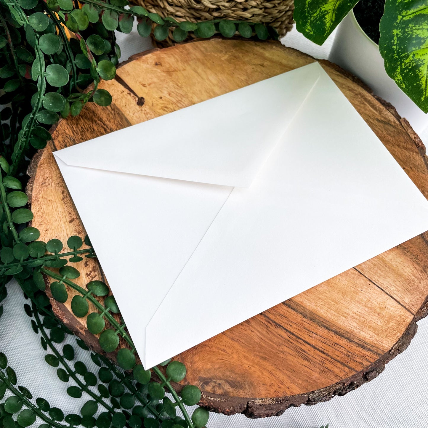 A 5x7" eco-friendly greeting card with original watercolor artwork from the Wild Planet Creations collection depicting a rainbow giraffe.