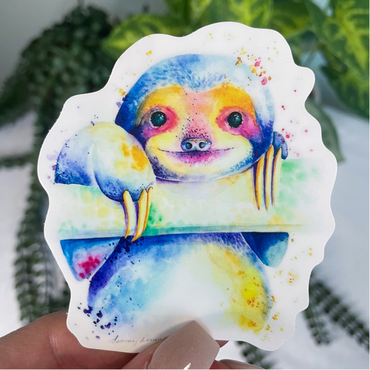 A close-up image of the waterproof, vinyl, dye-cut sticker depicting a watercolor painting from the Wild Planet Creations wild animal collection of a sloth.