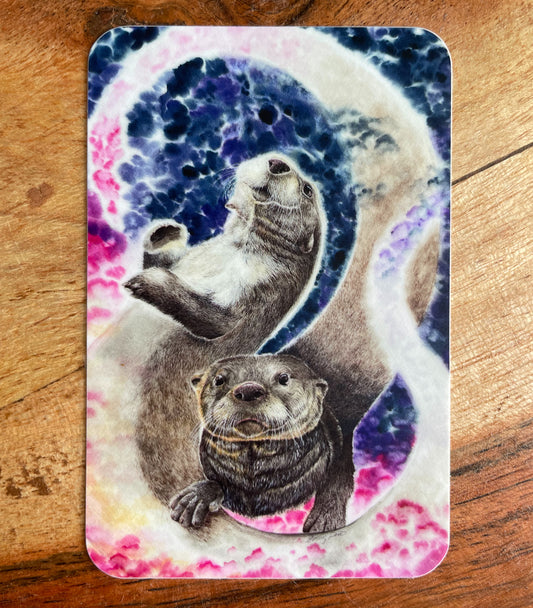 A close-up image of the waterproof, vinyl, dye-cut sticker depicting a watercolor painting from the Wild Planet Creations collection of two North American river otters