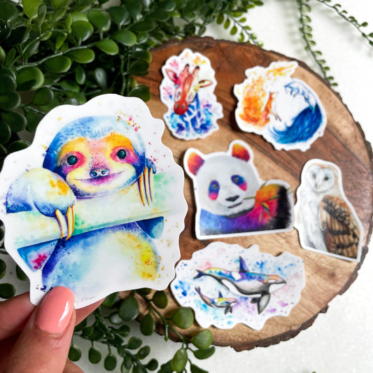 A close-up image of the waterproof, vinyl, dye-cut stickers depicting watercolor paintings from the Wild Planet Creations wild animal collection.