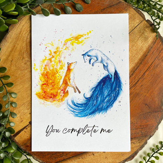 A 5x7" eco-friendly greeting card with original watercolor artwork from the Wild Planet Creations collection depicting fire and ice foxes.
