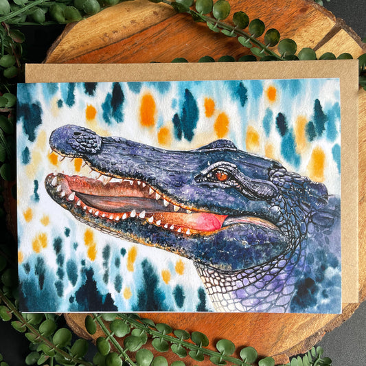 This 5x7" eco-friendly greeting card depicts a watercolor painting of an American alligator from the Wild Planet Creations collection. Each greeting card comes with an eco-friendly envelope and is blank on the inside so you can send any heart-felt message you want to a loved one.